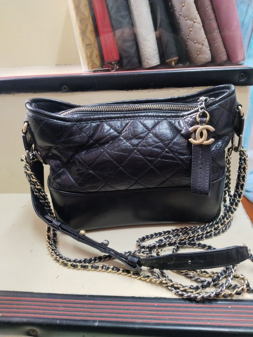 Chanel Gabrielle Hobo Bag Black (Category: Luxury Bags & Wallets) located in Baguio. Submitted by bangtowanv91137 (Listing ID 1425676988, Image 2). Description: Authentic Chanel Gabrielle Hobo bag in black. Features a quilted leather upper and a smooth leather base. The bag has a chain strap with leather detailing. The interior lining is red. Includes a zipper closure with a Chanel logo zipper pull. Made in Italy..