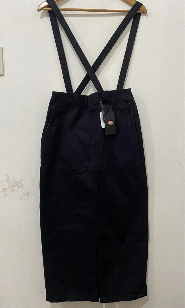 Dickies tight skirt with removable suspender (Category: Skirts) located in Pasig City. Submitted by psg2019 (Listing ID 1425678972, Image 1). Description: Dickies suspender skirt in black. Features a front slit and pockets. Includes original tags. The interior lining has a Dickies logo pattern. Size L. 28 waist 37 length brand new.
