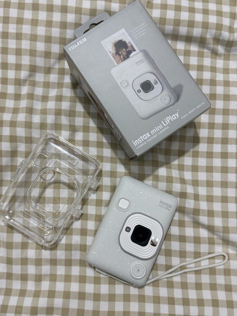 Sle Fujifilm Instax Mini LiPlay - Misty White (Category: Other Mobile & Gadget Accessories) located in Iloilo. Submitted by lovedbysachi (Listing ID 1425668430, Image 1). Description: Selling my Instax Mini LiPlay Hybrid Instant Camera in Milky White. In excellent condition with no issues. Rarely used and well taken care of. Price: ₱9,650 (FIXED) Inclusions: • Original box • Free clear protective case • Camera unit Note: • Charging cord is not in