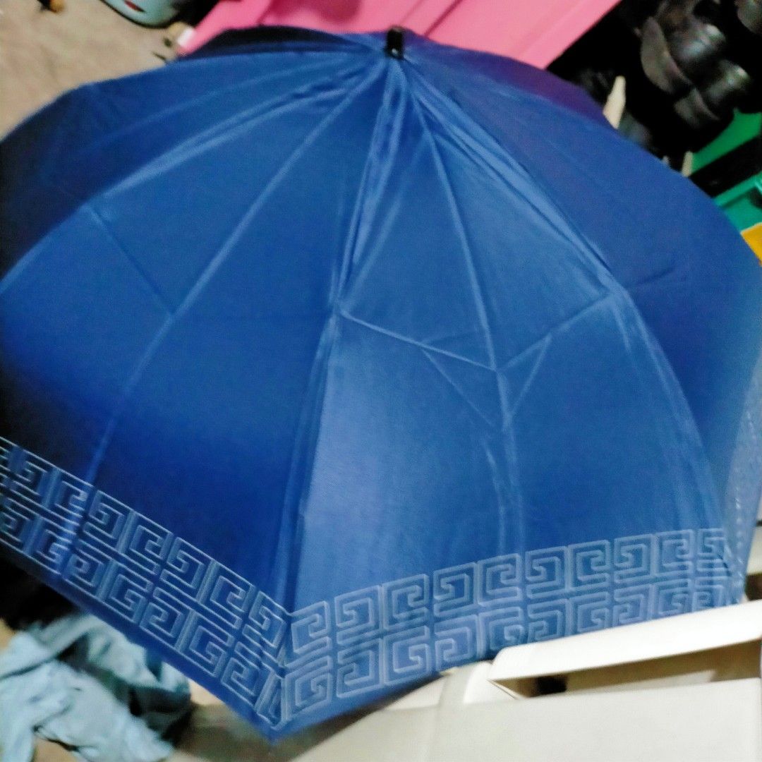 Givenchy 4G Logo Navy Blue Umbrella (Category: Umbrellas) located in Manila. Submitted by agenttin (Listing ID 1425771395, Image 2). Description: Navy blue Givenchy umbrella featuring the iconic 4G logo. The umbrella has a geometric pattern along the edges and on the storage case. The handle is black with the Givenchy logo. Includes a matching storage case. The tag is still attached..