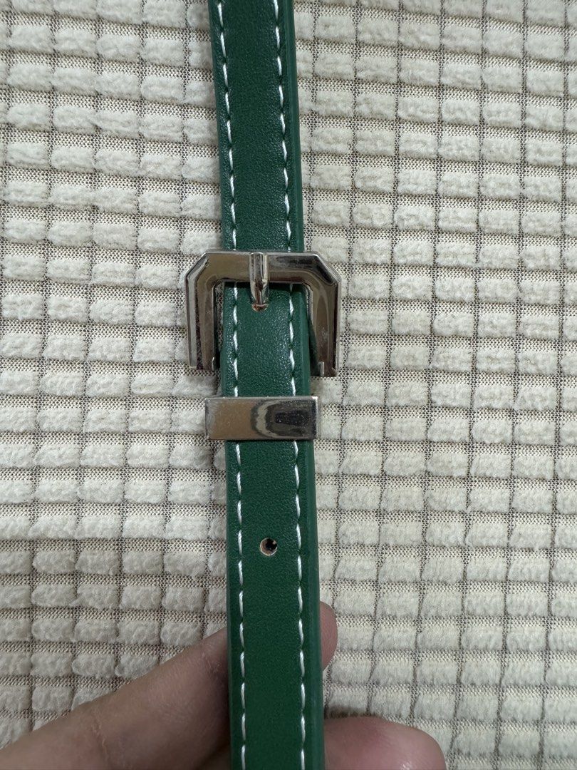 Goyard Belvedere Sling Bag (Category: Luxury Bags & Wallets) located in Cavite. Submitted by avikareyes1215 (Listing ID 1425729707, Image 3). Description: Goyard Belvedere Sling Bag - Color: Green with white stitching - Closure: Flap with silver-tone buckle - Interior: Yellow with multiple compartments - Strap: Adjustable green strap - Features the Goyard logo.