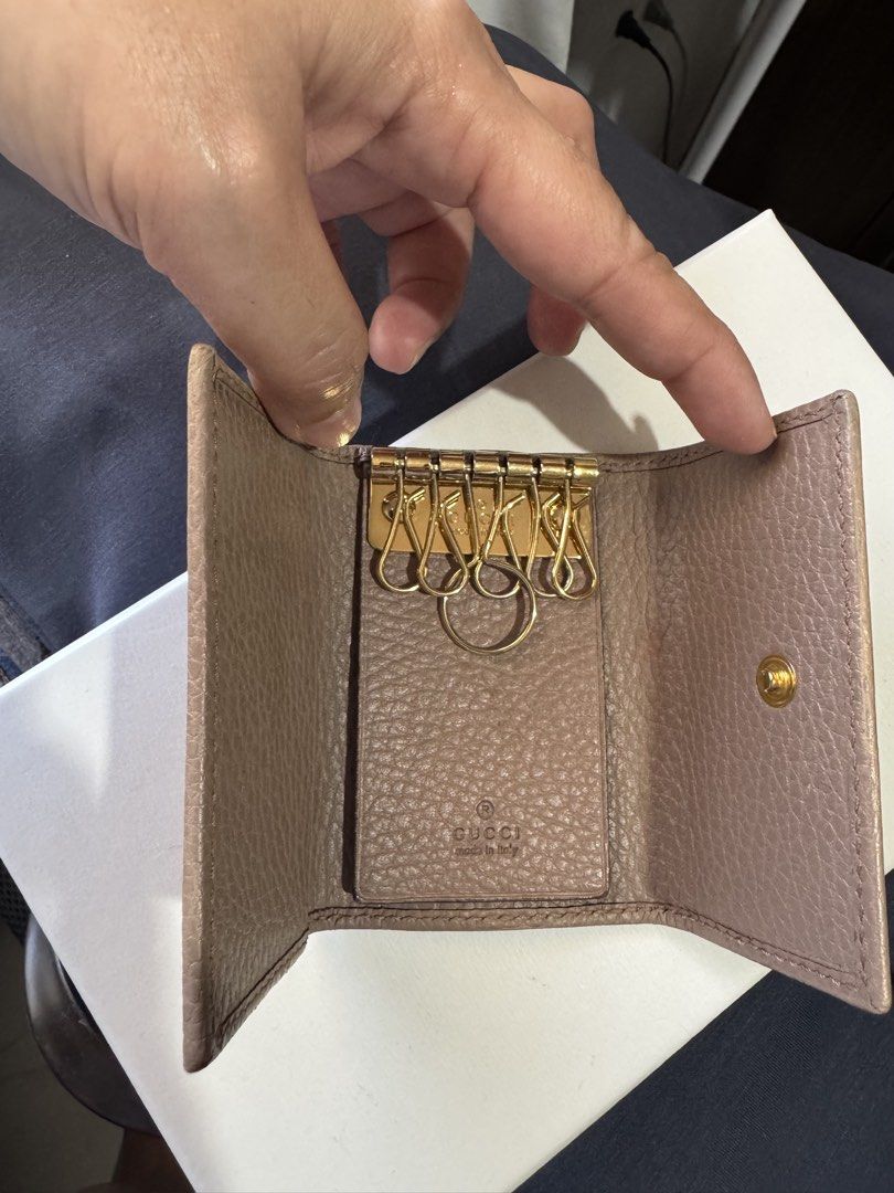 Gucci GG Marmont Key Case (Category: Luxury Bags & Wallets) located in Olongapo. Submitted by cynea16 (Listing ID 1425637441, Image 3). Description: Authentic Gucci GG Marmont key case. Features a beige leather exterior with a gold-tone GG logo. The interior has a key ring and multiple key hooks. Made in Italy. Includes a snap closure..