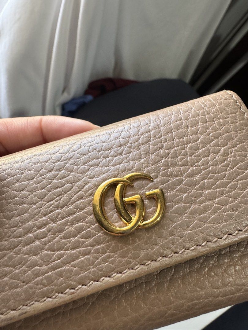 Gucci GG Marmont Key Case (Category: Luxury Bags & Wallets) located in Olongapo. Submitted by cynea16 (Listing ID 1425637441, Image 2). Description: Authentic Gucci GG Marmont key case. Features a beige leather exterior with a gold-tone GG logo. The interior has a key ring and multiple key hooks. Made in Italy. Includes a snap closure..