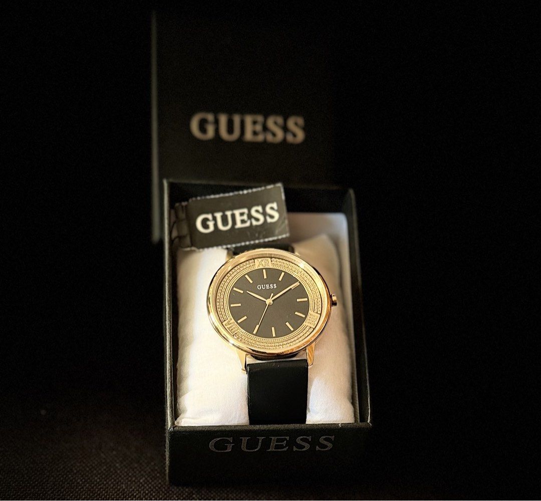 Guess Black-Gold Dial Analog Watch (Category: Women's Watches) located in Tarlac. Submitted by iamleeyam (Listing ID 1425821441, Image 1). Description: Guess Black-Gold Analog Watch From the US 🇺🇸 Like new, used once. Key Specifications: Case Size: Approximately 42 mm. Case Material: Gold-tone stainless steel with a crystal-encrusted bezel. Dial: Sleek black analog face with gold-tone markers and hands. Strap: Black silicone band for a blend of