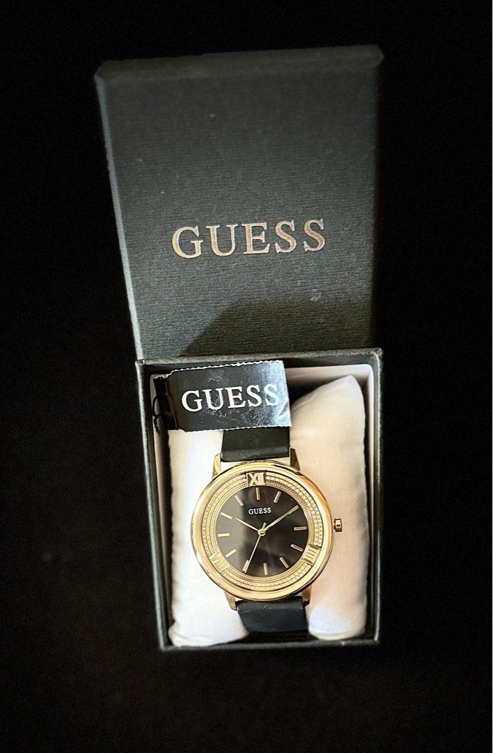 Guess Black-Gold Dial Analog Watch (Category: Women's Watches) located in Tarlac. Submitted by iamleeyam (Listing ID 1425821441, Image 3). Description: Guess Black-Gold Analog Watch From the US 🇺🇸 Like new, used once. Key Specifications: Case Size: Approximately 42 mm. Case Material: Gold-tone stainless steel with a crystal-encrusted bezel. Dial: Sleek black analog face with gold-tone markers and hands. Strap: Black silicone band for a blend of