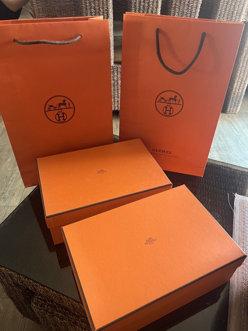Hermes Orange Boxes and Shopping Bags (Category: Luxury Bags & Wallets) located in Manila. Submitted by murafinds26 (Listing ID 1425646045, Image 3). Description: ₱5500 per set Can fit mini bags like mini Lindy , Constance 18 etc. Authentic Hermes orange boxes and shopping bags. Includes multiple boxes and shopping bags, perfect for gifting or storage. The boxes feature the Hermes logo on the top. The shopping bags also have the Hermes logo. A gr