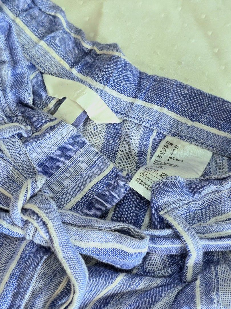 H&M Striped Linen Shorts (Category: Shorts) located in Cebu City. Submitted by sixfiftyfour (Listing ID 1425744826, Image 2). Description: Stylish H&M shorts in a blue and white striped pattern. Features a high waist design with a tie-waist detail. Made from a linen blend. The shorts have a comfortable fit, perfect for casual wear. Size is indicated as EUR 34, US 4, CA 4, CN 160/64A..