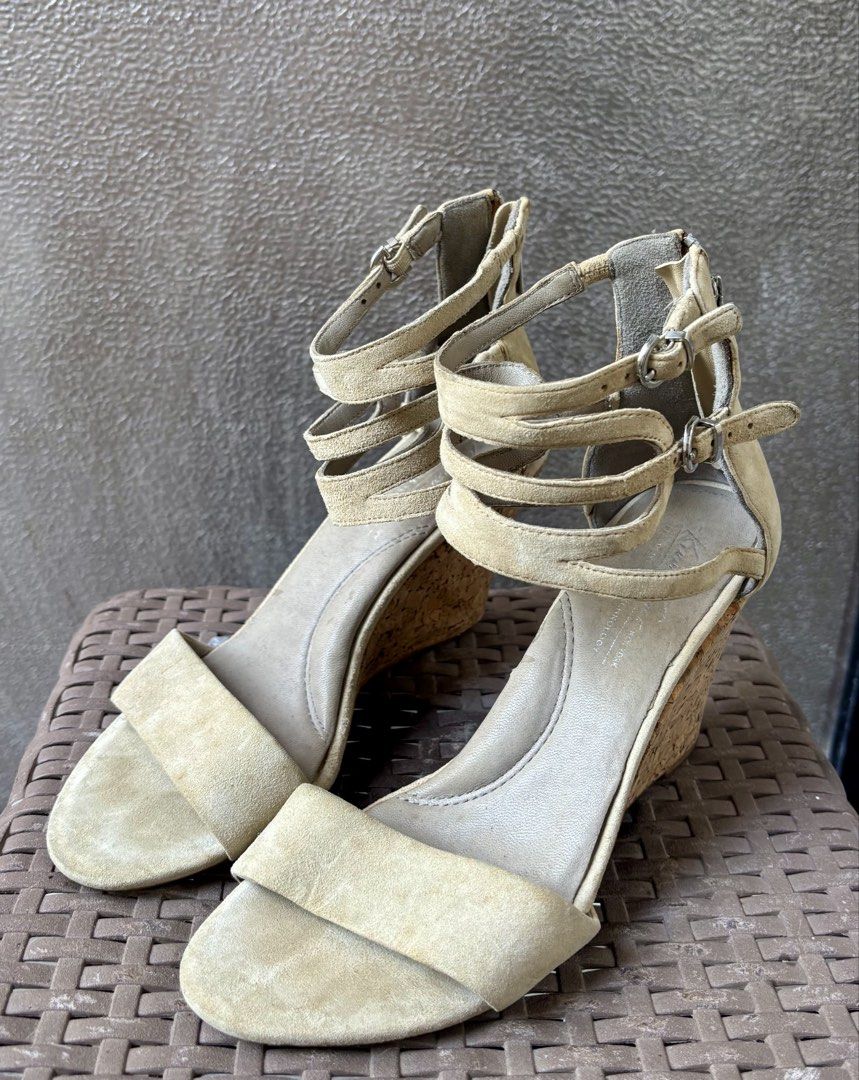 Kenneth Cole New York Wedge Sandals (Category: Wedges) located in Las Pinas. Submitted by dthreeonlineshop (Listing ID 1425658730, Image 2). Description: Kenneth Cole New York wedge sandals with a zipper closure. Features a cork wedge heel and multiple straps. The sandals have a beige suede upper and a size 7. The sole is marked with the Kenneth Cole New York logo. The sandals have some signs of wear..