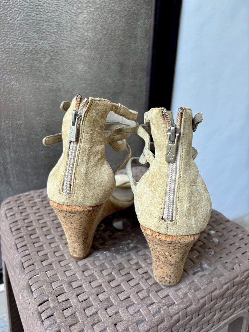 Kenneth Cole New York Wedge Sandals (Category: Wedges) located in Las Pinas. Submitted by dthreeonlineshop (Listing ID 1425658730, Image 3). Description: Kenneth Cole New York wedge sandals with a zipper closure. Features a cork wedge heel and multiple straps. The sandals have a beige suede upper and a size 7. The sole is marked with the Kenneth Cole New York logo. The sandals have some signs of wear..