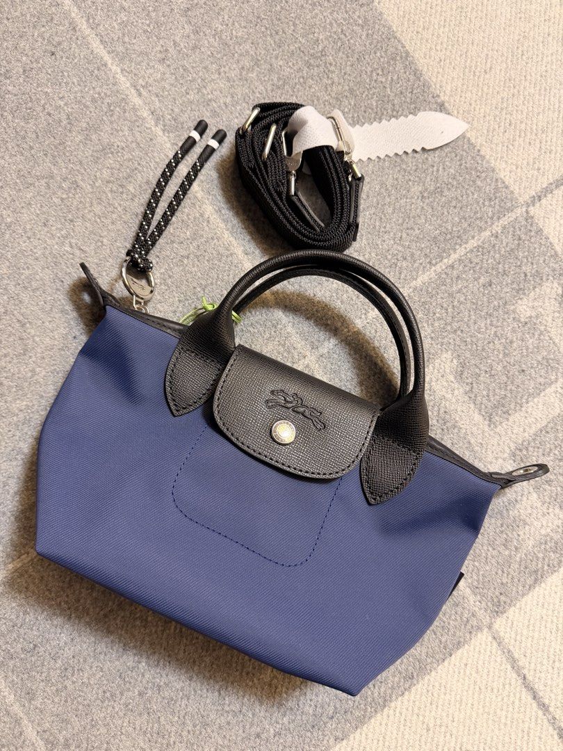 Longchamp Le Pliage Energy Top Handle Bag XS (Category: Luxury Bags & Wallets) located in Pasig City. Submitted by donmsamson (Listing ID 1425759340, Image 3). Description: A miniature version of Longchamp’s iconic top handle bag, Le Pliage Energy Top Handle Bag XS is the ideal glamor accessory to accompany you on all your evening events. Equipped with a short and removable shoulder strap, it can be carried either by hand or as a pouch. In this d