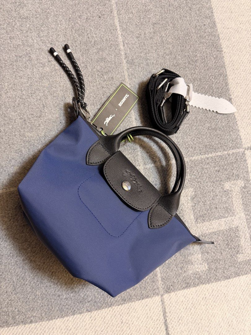 Longchamp Le Pliage Energy Top Handle Bag XS (Category: Luxury Bags & Wallets) located in Pasig City. Submitted by donmsamson (Listing ID 1425759340, Image 1). Description: A miniature version of Longchamp’s iconic top handle bag, Le Pliage Energy Top Handle Bag XS is the ideal glamor accessory to accompany you on all your evening events. Equipped with a short and removable shoulder strap, it can be carried either by hand or as a pouch. In this d