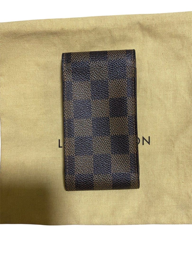 Louis Vuitton Damier Ebene Cigarette Case (Category: Luxury Bags & Wallets) located in Quezon City. Submitted by mcva2 (Listing ID 1425667429, Image 2). Description: Authentic Louis Vuitton wallet in Damier Ebene pattern. Features a brown and dark brown checkered design. Includes a dust bag with the Louis Vuitton logo. The interior is a solid brown color..