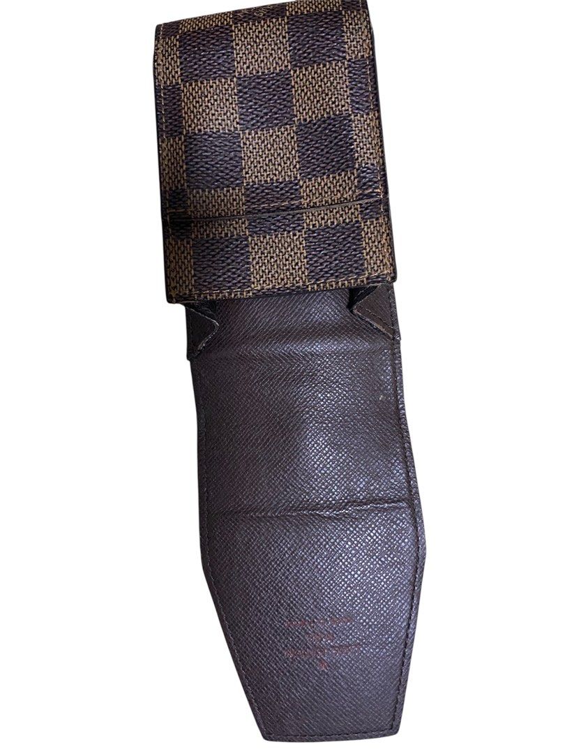 Louis Vuitton Damier Ebene Cigarette Case (Category: Luxury Bags & Wallets) located in Quezon City. Submitted by mcva2 (Listing ID 1425667429, Image 3). Description: Authentic Louis Vuitton wallet in Damier Ebene pattern. Features a brown and dark brown checkered design. Includes a dust bag with the Louis Vuitton logo. The interior is a solid brown color..