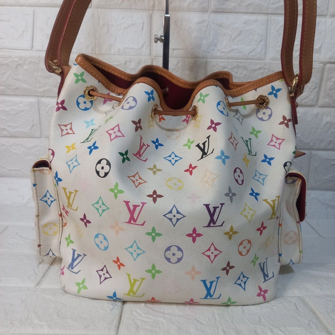 Louis Vuitton Multicolor White Bucket Bag (Category: Luxury Bags & Wallets) located in Las Pinas. Submitted by etoksi1234 (Listing ID 1425685559, Image 2). Description: Pre-loved Louis Vuitton Multicolor White Bucket Bag. Features the iconic multicolor monogram pattern. Includes a drawstring closure and a brown leather strap. The interior is lined with a burgundy fabric. Made in France. Includes a leather tag. The bag has two exterior pockets..