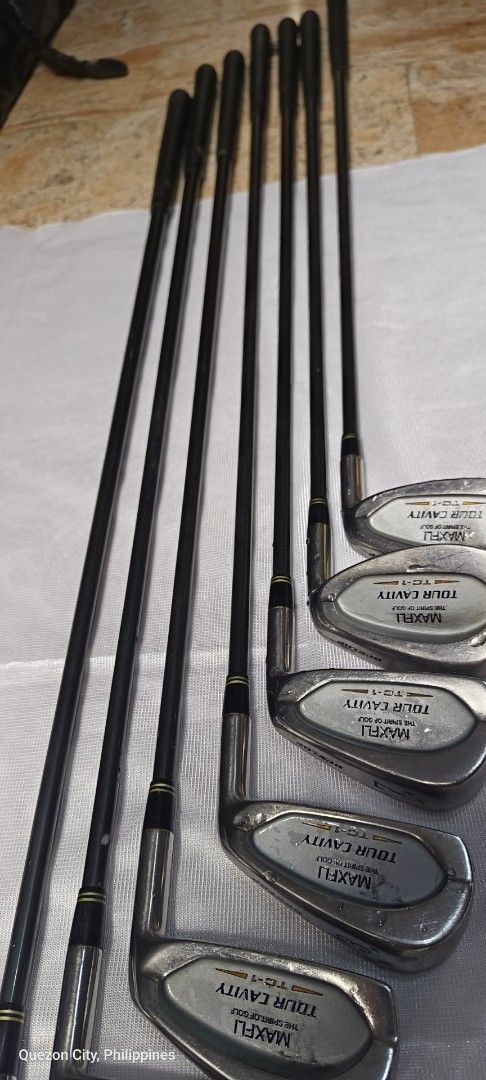 Maxfli Tour Cavity Golf Iron Set (Category: Golf) located in Manila. Submitted by yeonmei5614747 (Listing ID 1425648864, Image 2). Description: Complete set of Maxfli Tour Cavity golf clubs. Includes clubs numbered 3, 4, 5, 6, 7, 9, and A. The shafts are black with gold accents. The grips are black. Made in Japan..