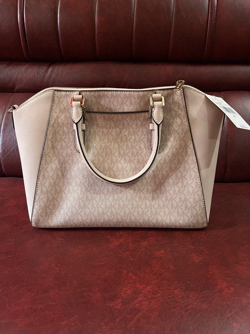 Michael Kors Ciara pink handbag (Category: Luxury Bags & Wallets) located in Cavite. Submitted by rov26 (Listing ID 1425653598, Image 2). Description: Authentic Michael Kors Handbag Condition: • Never used (w/ price tag $428) • Comes with detachable strap and care card • Minor cracking on the side edges due to long-term storage (purely cosmetic and does not affect functionality) Overall, it is still a beautiful and practical designer bag looking 