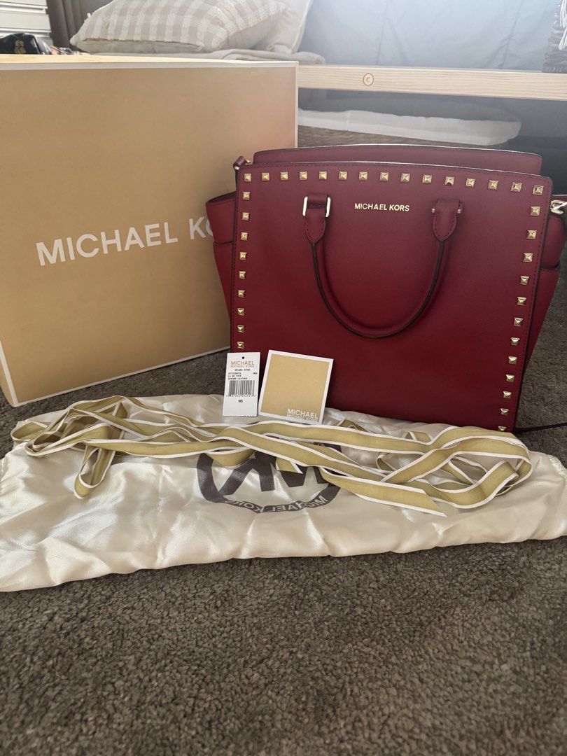 Michael Kors Selma Stud Medium Satchel Red Saffiano Leather Complete Set Authentic (Category: Luxury Bags & Wallets) located in Manila. Submitted by wisehorse.d929fd (Listing ID 1425633882, Image 1). Description: Michael Kors Selma Stud Medium Satchel Red Saffiano Leather with Gold Studs Authentic Michael Kors bag in very good condition. Structure is still firm and studs are all intact. Includes complete set: • Original Michael Kors box • Dust ba
