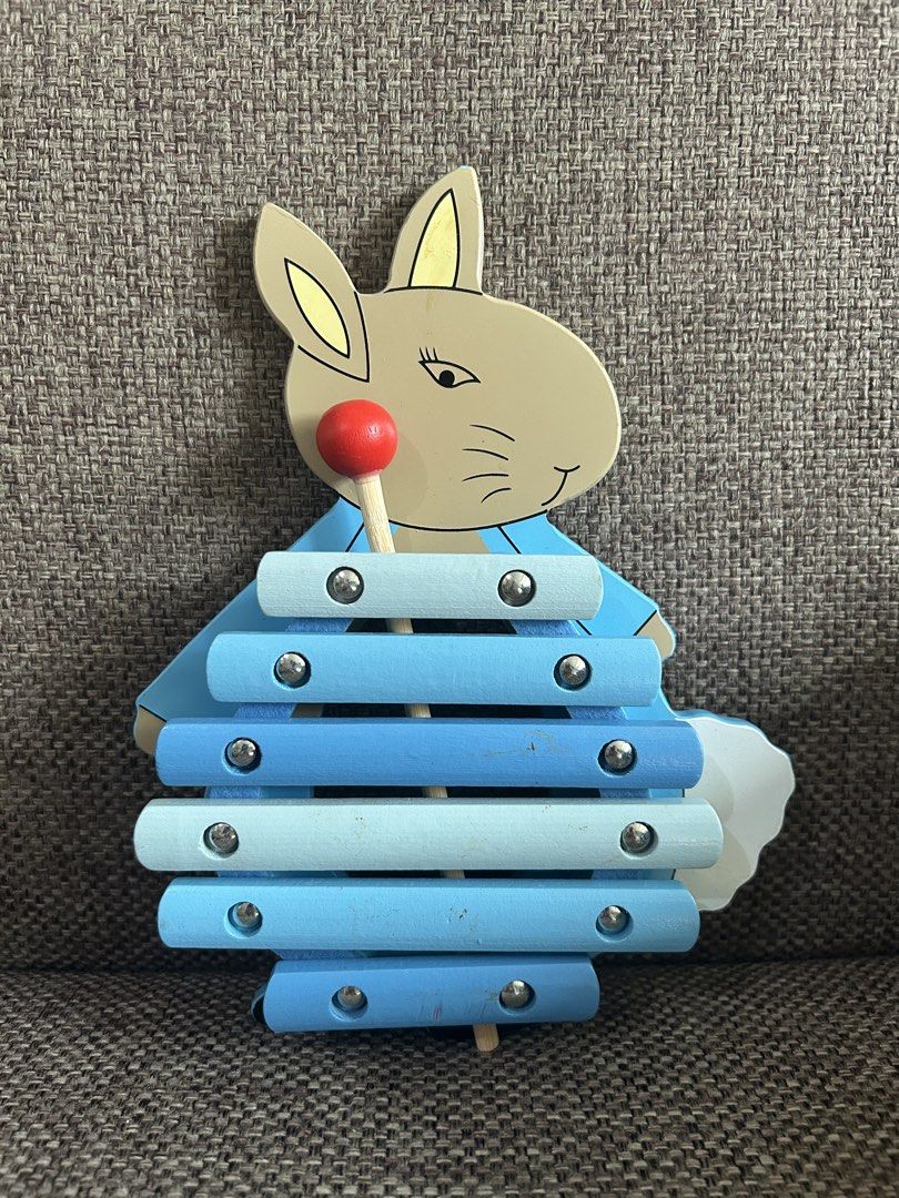 Orange Tree Toys Peter Rabbit Xylophone preloved (Category: Educational & Learning Toys) located in Marikina City. Submitted by cutesypatsy (Listing ID 1425642001, Image 1). Description: Adorable xylophone features a Peter Rabbit design. It is made by Orange Tree Toys and manufactured in China. The back of the xylophone has an egg-shaped cutout. The xylophone has blue bars and comes with a red-tipped mallet. The item is from 2019..