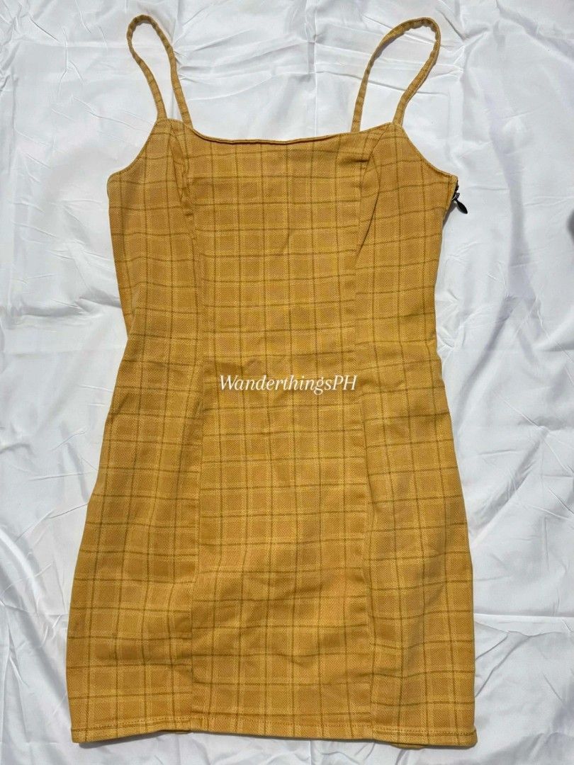 Plaid Denim Mini Yellow Dress (Category: Dresses) located in Malabon City. Submitted by WanderThingsPH (Listing ID 1425776757, Image 2). Description: Divided Yellow plaid mini dress with spaghetti straps. Features a side zipper. Fits a small size. Perfect for a casual day out or a summer gathering. The dress has a fitted silhouette..