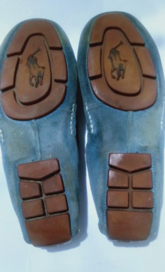 Polo Ralph Lauren Suede Loafers (Category: Dress Shoes) located in Naga. Submitted by pec3c (Listing ID 1425017882, Image 3). Description: These Polo Ralph Lauren loafers feature a suede upper in a blue-grey color. They have a classic penny loafer design with a stitched detail around the top. The insole is a light brown leather, and the Polo logo is visible. The soles show some wear..