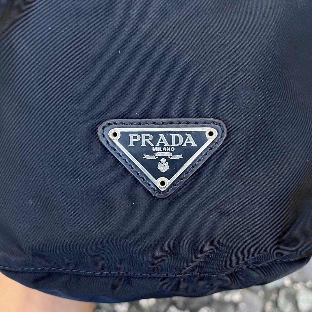 Prada Nylon Drawstring Pouch Bag (Category: Luxury Bags & Wallets) located in Quezon City. Submitted by forgarments (Listing ID 1425816658, Image 3). Description: Prada Nylon Drawstring Pouch Bag Good Condition - Scatches / burn mark - Missing white tag (authentic) Width: 8 Inches Height: 8.5 Inches Depth: 4.5 Inches Compact pouch bag by Prada crafted from the brand’s signature technical nylon, known for its lightweight durability and resistance 
