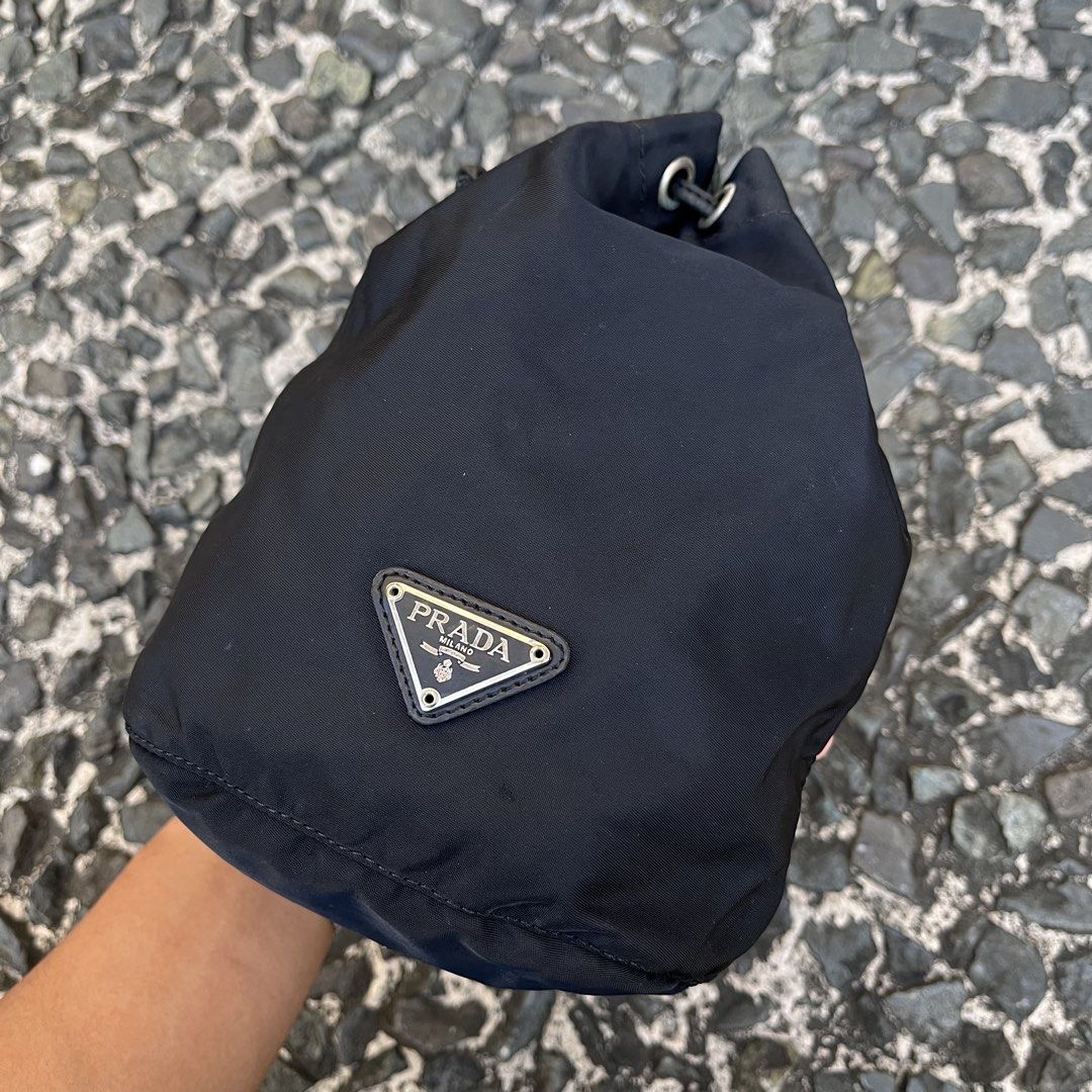 Prada Nylon Drawstring Pouch Bag (Category: Luxury Bags & Wallets) located in Quezon City. Submitted by forgarments (Listing ID 1425816658, Image 2). Description: Prada Nylon Drawstring Pouch Bag Good Condition - Scatches / burn mark - Missing white tag (authentic) Width: 8 Inches Height: 8.5 Inches Depth: 4.5 Inches Compact pouch bag by Prada crafted from the brand’s signature technical nylon, known for its lightweight durability and resistance 