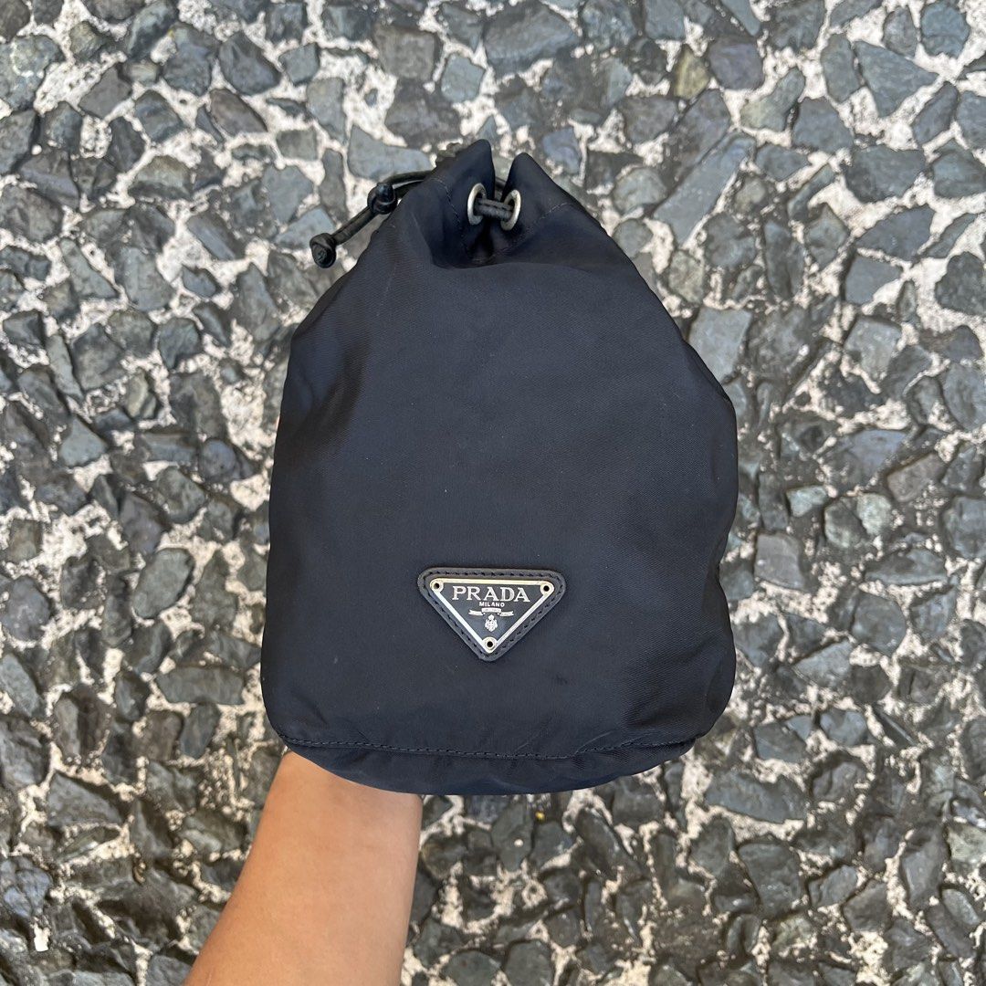Prada Nylon Drawstring Pouch Bag (Category: Luxury Bags & Wallets) located in Quezon City. Submitted by forgarments (Listing ID 1425816658, Image 1). Description: Prada Nylon Drawstring Pouch Bag Good Condition - Scatches / burn mark - Missing white tag (authentic) Width: 8 Inches Height: 8.5 Inches Depth: 4.5 Inches Compact pouch bag by Prada crafted from the brand’s signature technical nylon, known for its lightweight durability and resistance 