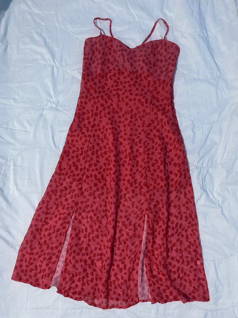 Red Spaghetti Strap Floral Slit Midi A-Line Dress (Category: Dresses) located in Makati City. Submitted by eunaj (Listing ID 1425752012, Image 1). Description: Midi dress features a vibrant red floral pattern. It has a sweetheart neckline, adjustable spaghetti straps, and a flattering A-line silhouette. The dress includes two side slits for added movement and style. The back has a tie detail for a customizable fit. Perfect for a summer day out or