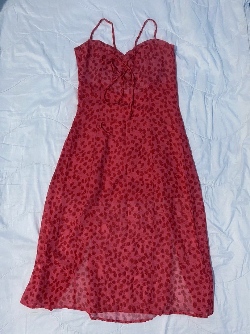 Red Spaghetti Strap Floral Slit Midi A-Line Dress (Category: Dresses) located in Makati City. Submitted by eunaj (Listing ID 1425752012, Image 2). Description: Midi dress features a vibrant red floral pattern. It has a sweetheart neckline, adjustable spaghetti straps, and a flattering A-line silhouette. The dress includes two side slits for added movement and style. The back has a tie detail for a customizable fit. Perfect for a summer day out or