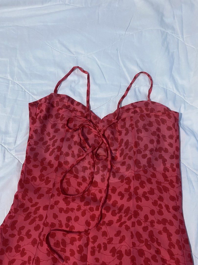 Red Spaghetti Strap Floral Slit Midi A-Line Dress (Category: Dresses) located in Makati City. Submitted by eunaj (Listing ID 1425752012, Image 3). Description: Midi dress features a vibrant red floral pattern. It has a sweetheart neckline, adjustable spaghetti straps, and a flattering A-line silhouette. The dress includes two side slits for added movement and style. The back has a tie detail for a customizable fit. Perfect for a summer day out or