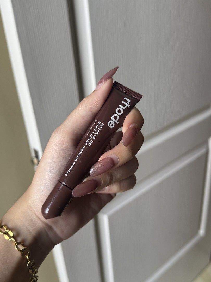 Rhode Peptide Lip Tint - Espresso (Category: Makeup) located in Mandaluyong City. Submitted by goodfindsaf (Listing ID 1425483503, Image 3). Description: Rhode Peptide Lip Tint in Espresso shade. This lip tint provides a touch of color and hydration. The product is 10 ml / 0.3 fl oz. The image shows the product and a swatch of the Espresso color..