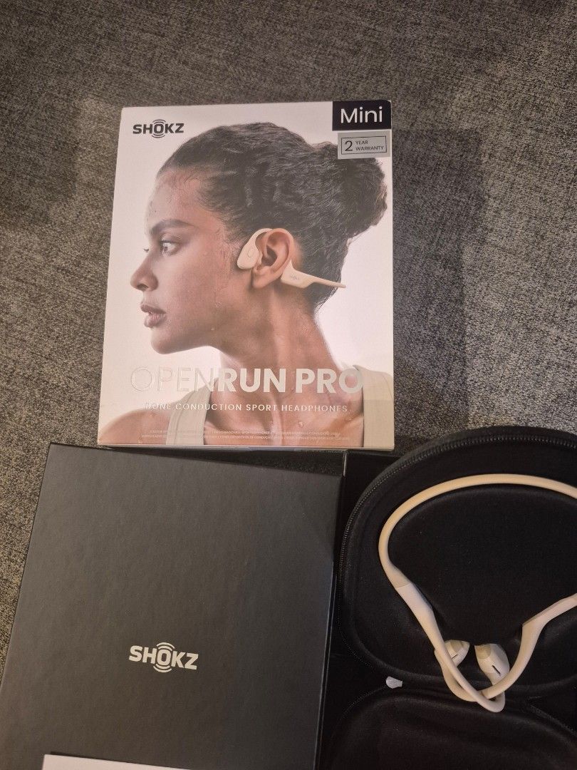 Shokz .OpenRun Pro Mini Bone Conduction Headphones (Category: Headphones & Headsets) located in Davao. Submitted by marthascloset (Listing ID 1425816012, Image 3). Description: Shokz OpenRun Pro Mini bone conduction headphones. Includes the headphones, a carrying case, a charging cable, the original box, and documentation. The headphones are white and black. The box indicates it is the Mini version. The model is OpenRun Pro..