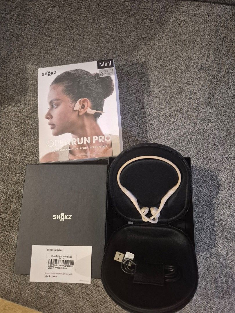 Shokz .OpenRun Pro Mini Bone Conduction Headphones (Category: Headphones & Headsets) located in Davao. Submitted by marthascloset (Listing ID 1425816012, Image 1). Description: Shokz OpenRun Pro Mini bone conduction headphones. Includes the headphones, a carrying case, a charging cable, the original box, and documentation. The headphones are white and black. The box indicates it is the Mini version. The model is OpenRun Pro..