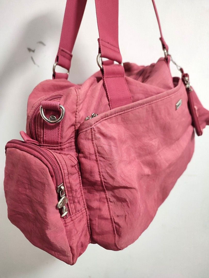Snoopy Pink Shoulder on the go Bag (Category: Shoulder Bags) located in Davao. Submitted by second.chances.preloves (Listing ID 1425809476, Image 2). Description: Snoopy peanuts with etiketa lots of zipper compartment with small pouch pa large size, long handle can be a weekender bag or gym bag or on the go bag! pink-red color same tela kay kipling, washable super cute! no sling, pero pwede malagyan 15x11 inches ❌bawal sa arte ❌no return, no exch