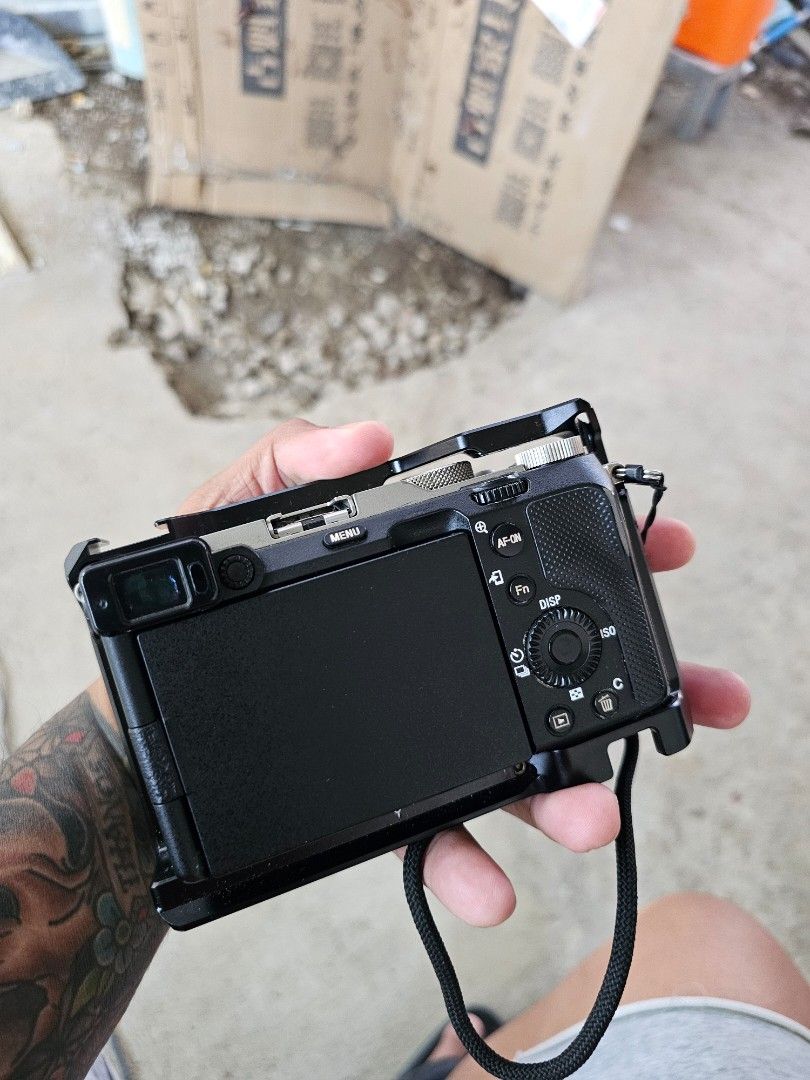 Sony Alpha 7C Camera with Tamron 28-75mm Lens (Category: Cameras) located in Quezon City. Submitted by jerome2929 (Listing ID 1425703403, Image 3). Description: Selling a Sony Alpha 7C camera with a Tamron 28-75mm f/2.8 Di III VXD G2 lens. Includes a SmallRig cage for the camera. The lens has a lens hood. The camera has a lens cap. The camera has a strap attached. The camera has a cover on the LCD screen. The camera is black..