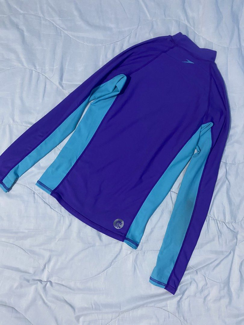Speedo Long Sleeve Rash Guard Size 14 (Category: Rash guard) located in Makati City. Submitted by eunaj (Listing ID 1425768239, Image 2). Description: Speedo long sleeve rash guard in navy blue and peach. Features a high neck and Speedo logo on the front. Size 14. Made of 85% polyester and 15% spandex. SPF 50. Fit to S-L size ✔️ Used twice only ✔️ .