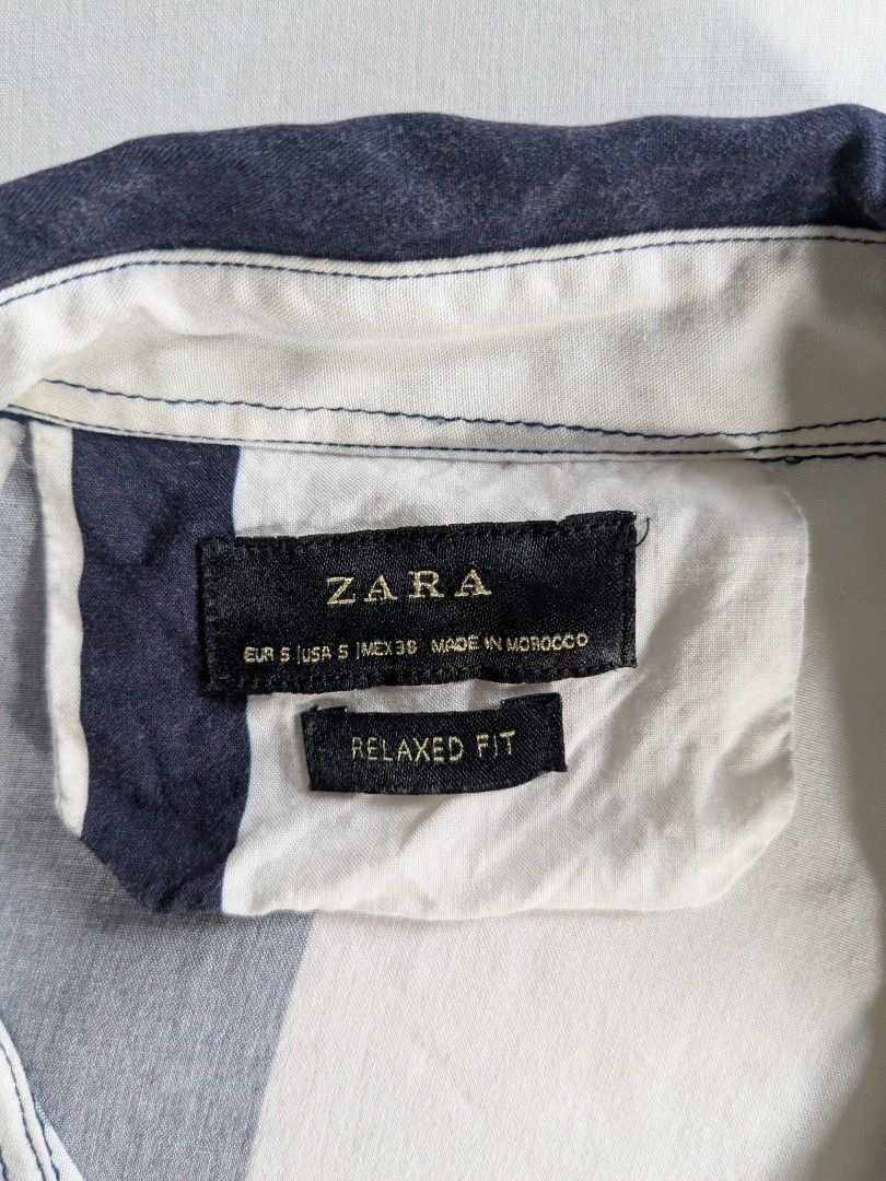 Zara Button Up Striped Polo Shirt - Small (Category: Tshirts & Polo Shirts ) located in Quezon City. Submitted by frankmountain (Listing ID 1425789423, Image 3). Description: - Zara Button-Up Polo Shirt - Size: Small - Striped design (navy, white, red) - Relaxed fit - Perfect Condition. No issues - Made in Morocco.
