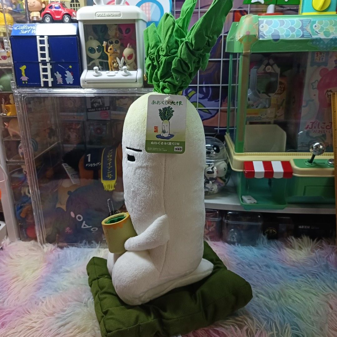 Takara 2004 Aokubi Daikon Plush Toy (Category: Plushies & Soft Toys) located in Paranaque City. Submitted by niropa (Listing ID 1425828037, Image 2). Description: Adorable Aokubi Daikon plush toy is a must-have for collectors! It features a radish character holding a cup and sitting on a green cushion. The plush has a tag attached. The toy is white with green leaves and a serene expression. It is a Takara Kiddy Land product..