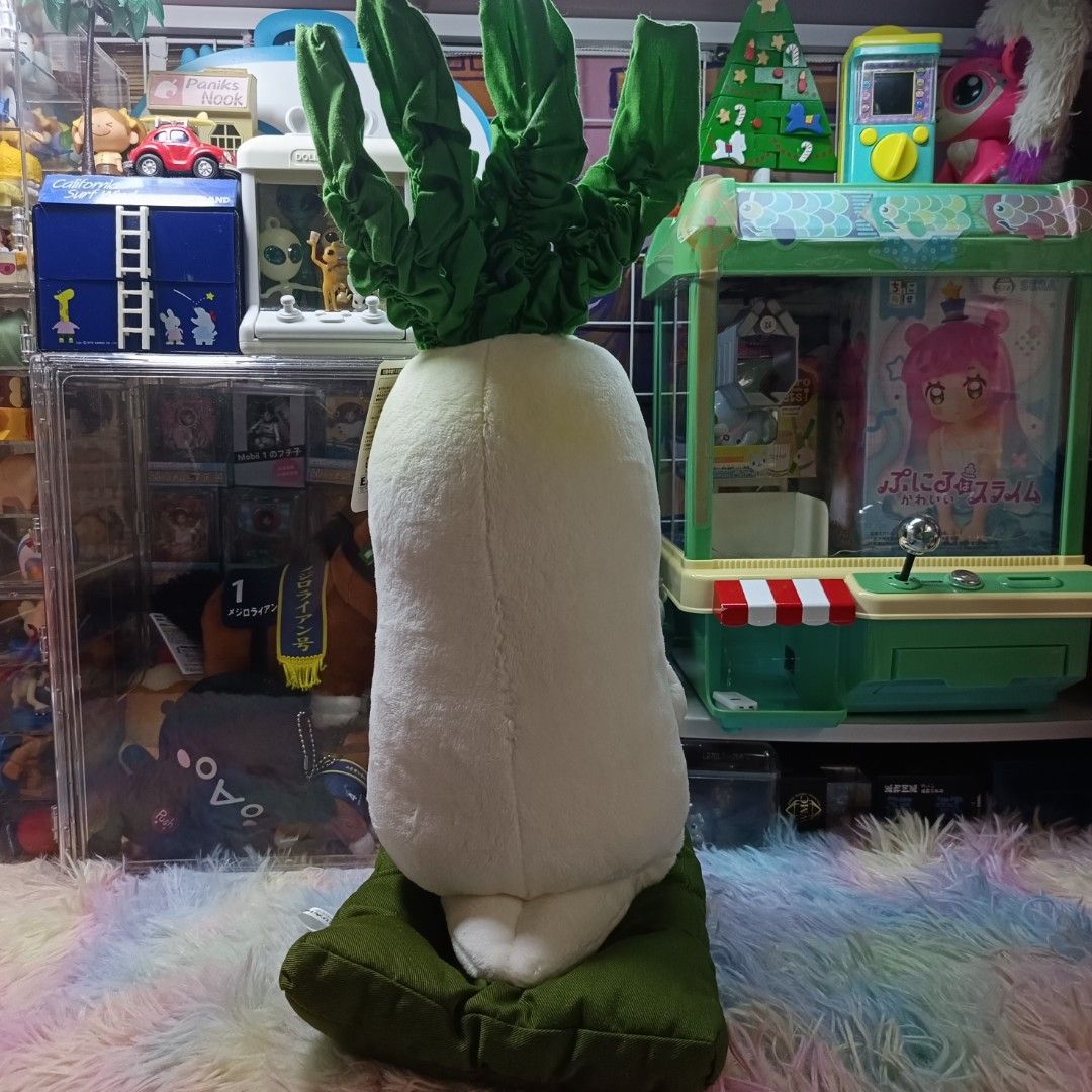 Takara 2004 Aokubi Daikon Plush Toy (Category: Plushies & Soft Toys) located in Paranaque City. Submitted by niropa (Listing ID 1425828037, Image 3). Description: Adorable Aokubi Daikon plush toy is a must-have for collectors! It features a radish character holding a cup and sitting on a green cushion. The plush has a tag attached. The toy is white with green leaves and a serene expression. It is a Takara Kiddy Land product..
