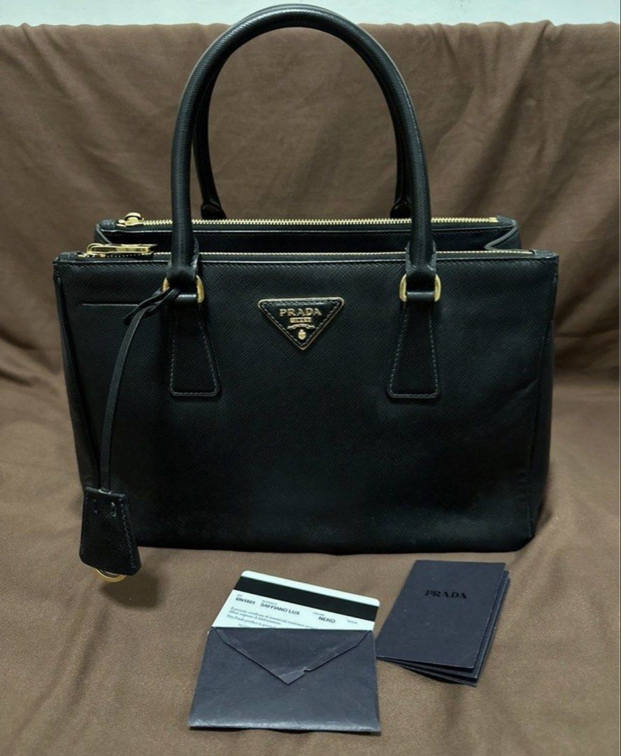 Authentic Prada Saffiano Lux Double Zipper Tote Nero (Category: Luxury Bags & Wallets) located in Cavite. Submitted by trendydotnet (Listing ID 1425872198, Image 1). Description: READ BELOW! SWIPE➡️ PHOTO DETAILS 🔍ITEM GUARANTEED 💯% AUTHENTIC Authėntic PRADA Saffiano Lux Double Zipper Tote Nero -Inclusion: Authenticity Card Only -Bought in Australia -Color: Black -Gold hardware still ok not so faded -Clean Interior -One zipper pull came off. Mi