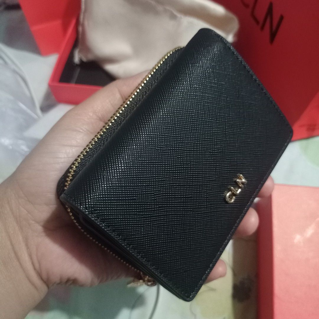 CLN Black Wallet (Category: Wallets & Card holders) located in Manila. Submitted by grandcat-96b481 (Listing ID 1425865435, Image 1). Description: Black CLN wallet with gold-colored zipper and logo. Features multiple compartments for cards and cash. Includes a box and a dust bag. The wallet has a snap closure and a zippered compartment. The CLN logo is visible on the front of the wallet..