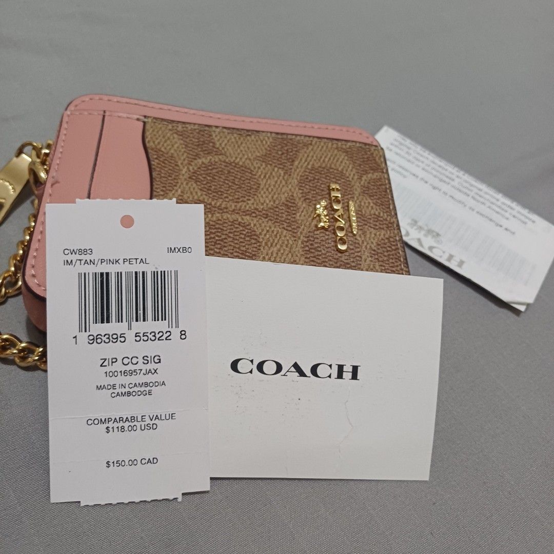 Coach Zip CC S/G Card Holder pink (Category: Luxury Bags & Wallets) located in Paranaque City. Submitted by potatoiceblended (Listing ID 1425920142, Image 2). Description: Coach card holder with a zip closure. Features a signature Coach print with pink accents and a gold chain. Includes card slots and a zip compartment. The tag indicates the style is IM/TAN/PINK PETAL. Made in Cambodia. authentic. i can provide receipt..