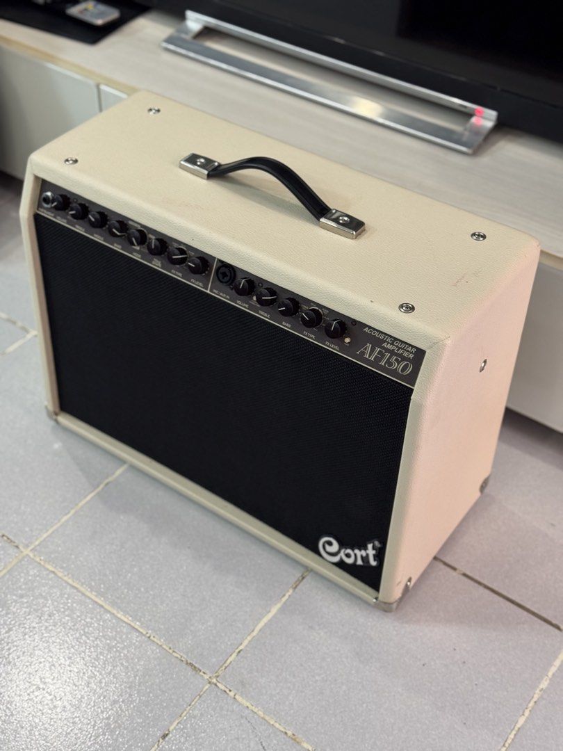 Cort AF150 Acoustic Guitar Amplifier (Category: Soundbars, Speakers & Amplifiers) located in Talisay. Submitted by kim_rey (Listing ID 1425955183, Image 2). Description: The Cort AF150 is a 150-watt RMS acoustic guitar amplifier designed for rich, balanced sound in small venues, featuring dual 8-inch woofers and a tweeter. Key specifications include, 2 * 75W power output, 4-band graphic EQ, built-in DSP (chorus/delay), and a notch filter for feed