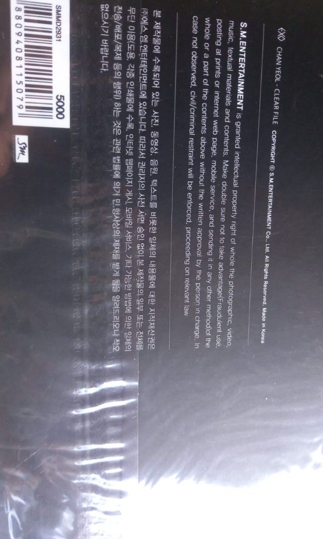 EXO Overdose Clear File Lay Ver. (Category: K-Wave Merchandise) located in Rizal. Submitted by angelfruitph (Listing ID 1424278598, Image 2). Description: Kpop folder featuring a male artist. It is sealed in its original packaging. The folder has a black background with the artist's image in the center. It has a hole at the top for hanging and a small circular cut-out on the right side..