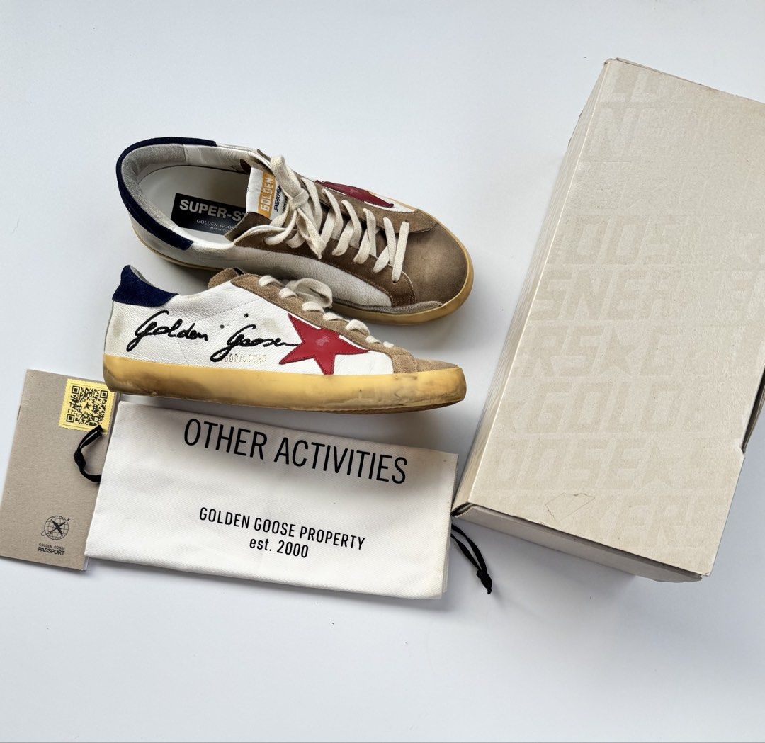 Golden Goose Superstar Sneakers (Category: Sneakers) located in Davao. Submitted by LUXURY (Listing ID 1425876448, Image 1). Description: Golden Goose Deluxe Brand Golden Goose Superstar sneakers. Features a white leather upper with a red star detail. Includes the original box, dust bag, and authentication card. Size 42 Visit my profile for more luxury items.