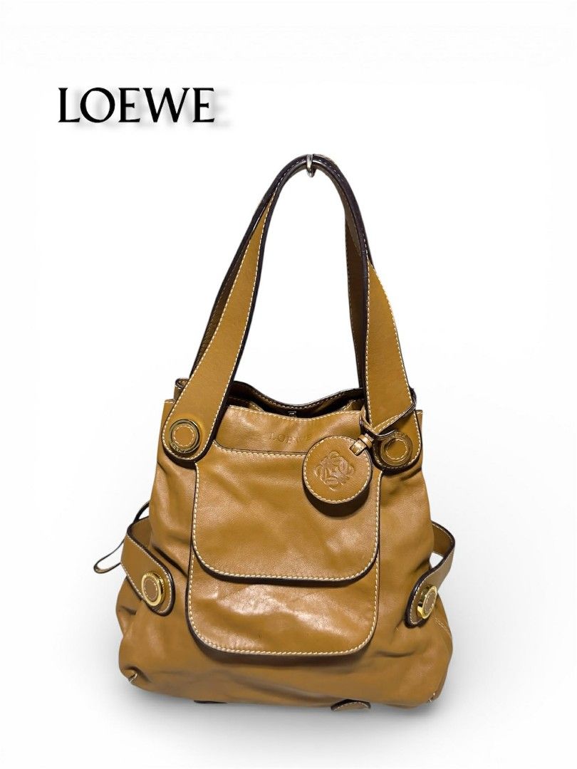 Loewe Velazquez Twist Drawstring Shoulder Bag (authentic) (Category: Luxury Bags & Wallets) located in Cebu City. Submitted by westleygics18 (Listing ID 1425991748, Image 1). Description: Loewe Velazquez Twist Drawstring Shoulder Bag (authentic) - Excellent Condition -W/authenticity card model,serial number - Style: Bucket-style drawstring shoulder bag - Camel / Tan with high-shine gold-tone metal hardware. - Ultra-soft Nappa Lambskin leather wit