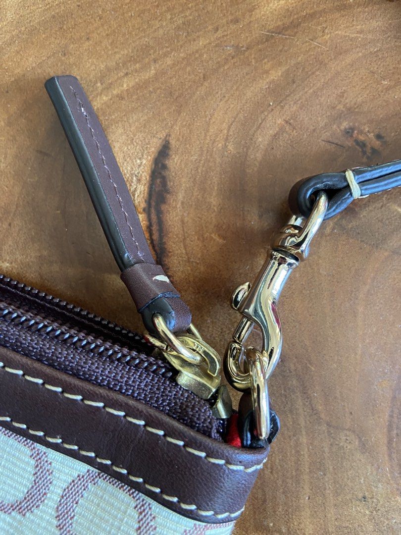ORIGINAL DOONEY & BOURKE Wristlet (Category: Luxury Bags & Wallets) located in Manila. Submitted by purselady (Listing ID 1425891534, Image 3). Description: Description: -off white + brown fabric material -leather trim and handles -gold-tone hardwares -1 main compartment, zipper closure -1 open interior pocket -15 inches strap/handle (end to end) -5 inches height x 8 inches width *NO ISSUE *Still with certificate of authenticity *Open for reasona