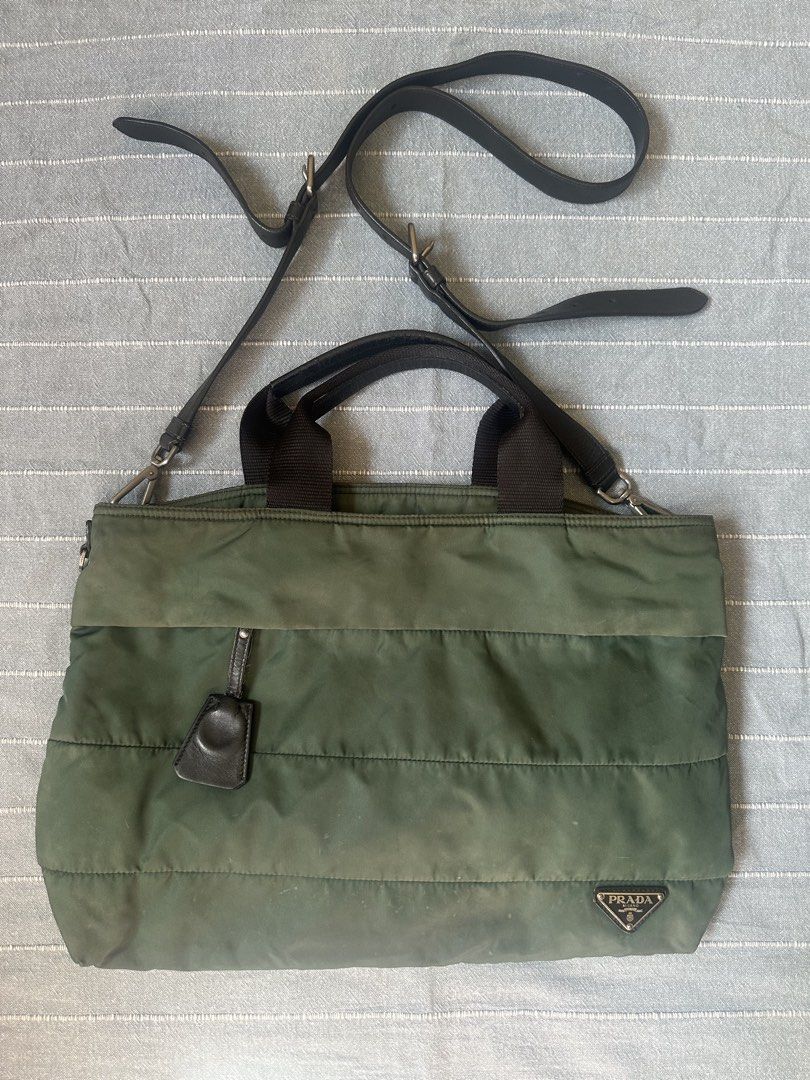 Prada Green Two Way Nylon Bag (Category: Luxury Bags & Wallets) located in Mandaluyong City. Submitted by marceditems (Listing ID 1425825499, Image 1). Description: Authentic Prada two way nylon bag in green. Features a quilted design, top handles, and a detachable long strap. The interior has a Prada Milano label and a zipper closure. Includes a small leather tag and metal hardware with the Prada logo. Made in Italy. Callout is discoloration and