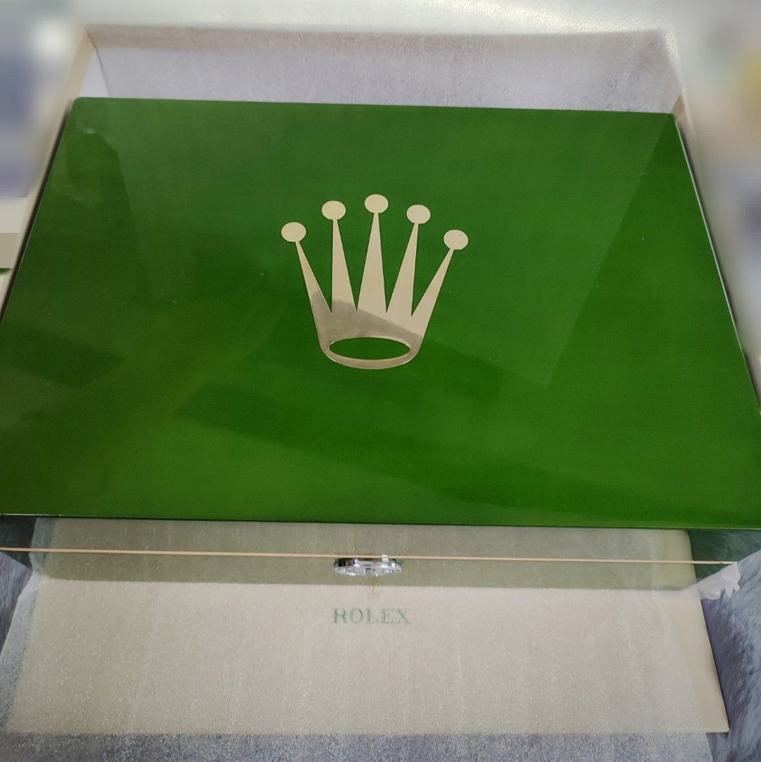 Rolex Watch Box (Category: Luxury Watches) located in Manila. Submitted by dconlinesh14898 (Listing ID 1425983395, Image 1). Description: Genuine Rolex watch box. Features a green exterior with the Rolex logo. The interior is designed to hold multiple watches, with individual compartments. Includes the original outer box and paperwork. A stylish and secure storage solution for your valuable timepieces..