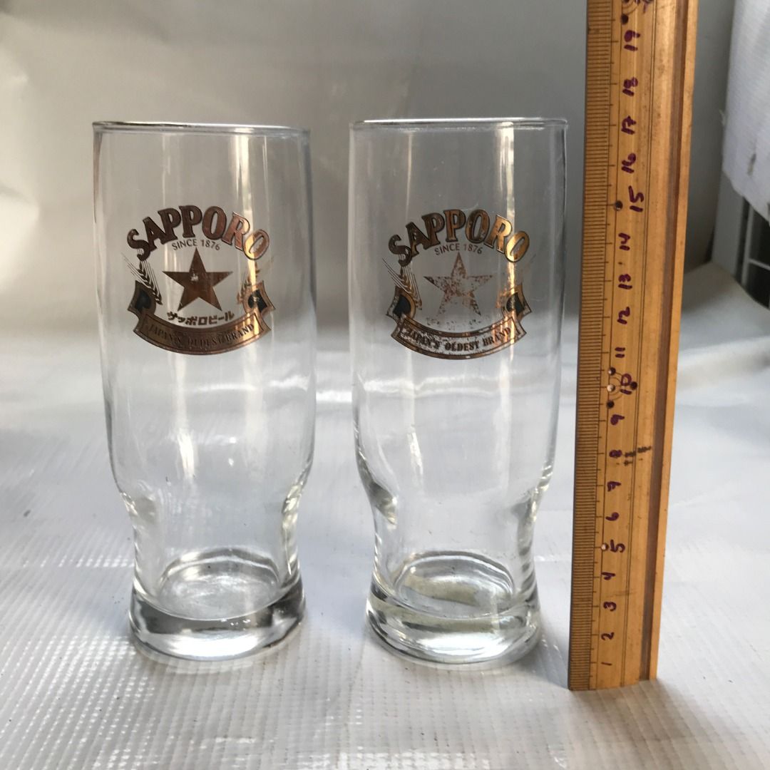 Sapporo Beer Glass #4443 (Category: Water Bottles & Tumblers) located in Malabon City. Submitted by mldg.surplus (Listing ID 1425874212, Image 1). Description: Set of two Sapporo beer glasses. Features the Sapporo logo with a star and banner. The glasses are clear and cylindrical. The text "SINCE 1876" and "JAPAN'S OLDEST BRAND" are visible on the glasses. Perfect for enjoying your favorite beer. MLDG Surplus Reminder: •Expect minimal flaws such 